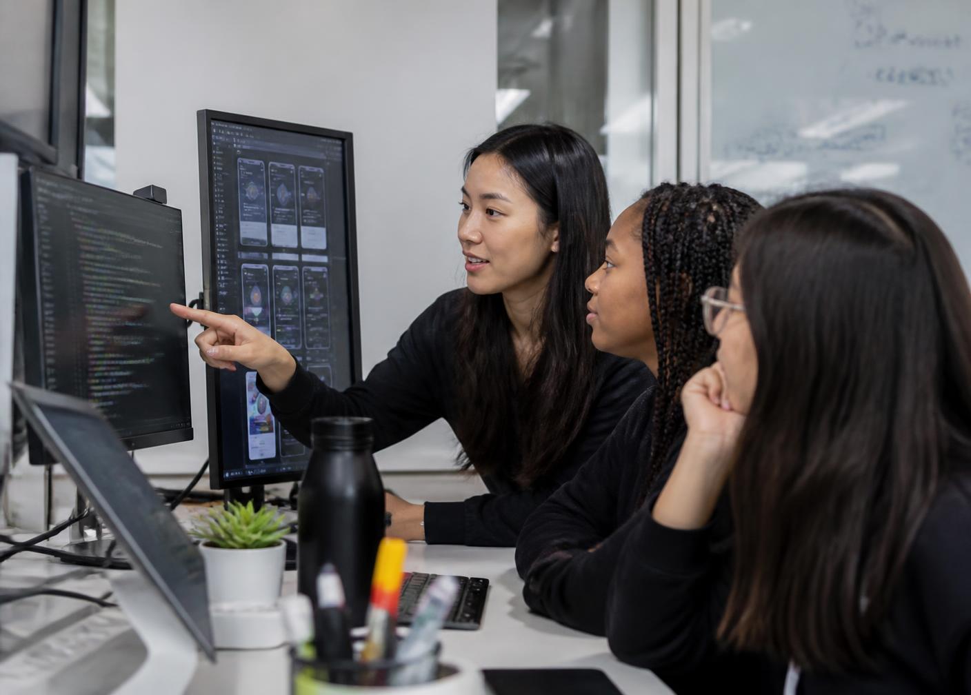 A high school girl working with a technology mentor